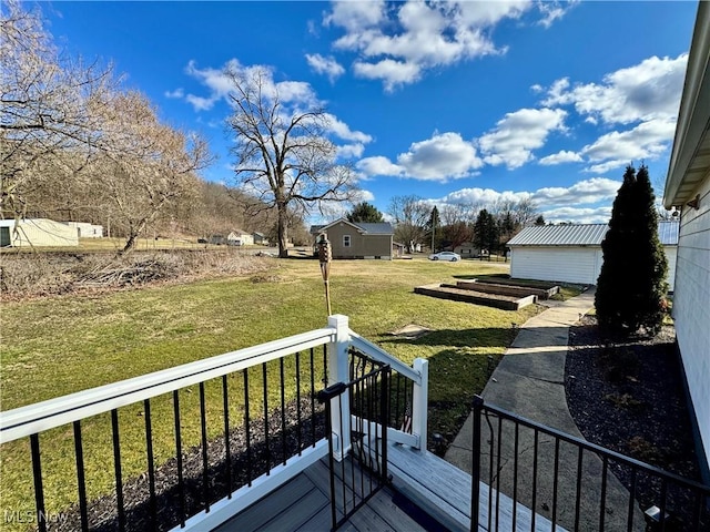 wooden deck featuring a lawn