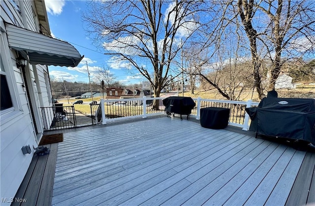 wooden terrace with a grill