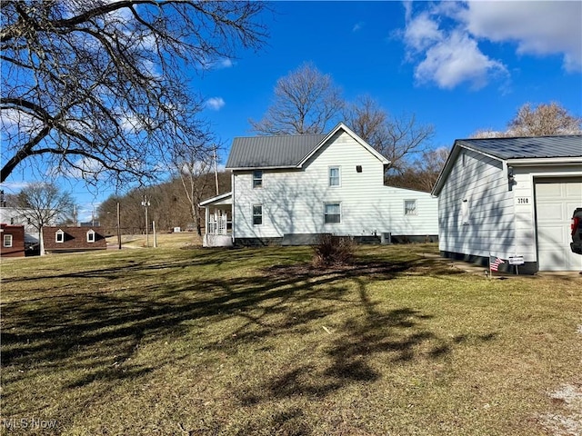 view of property exterior with metal roof and a lawn