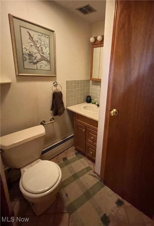 bathroom with visible vents, toilet, a baseboard radiator, vanity, and backsplash