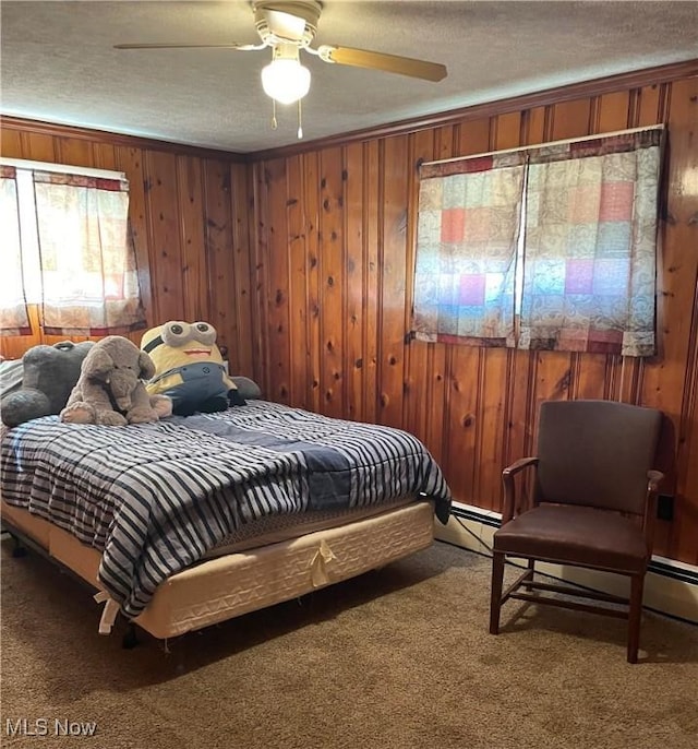 bedroom featuring wooden walls, carpet, crown molding, and a textured ceiling