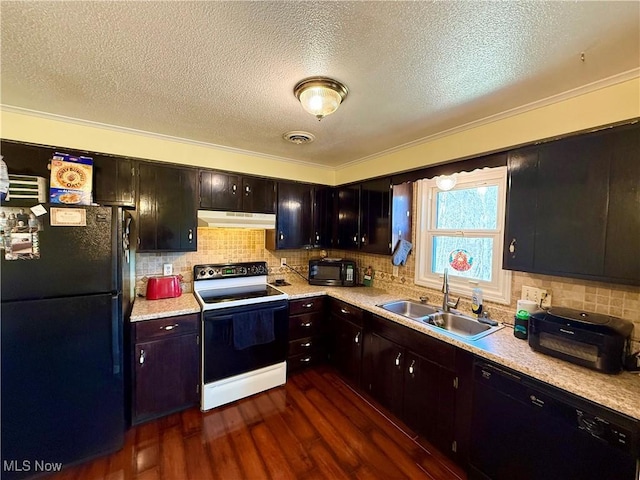 kitchen featuring under cabinet range hood, dark wood-type flooring, visible vents, light countertops, and black appliances