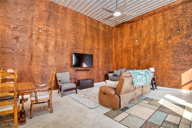 unfurnished living room with baseboards and concrete flooring