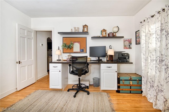 home office featuring light wood-type flooring and baseboards