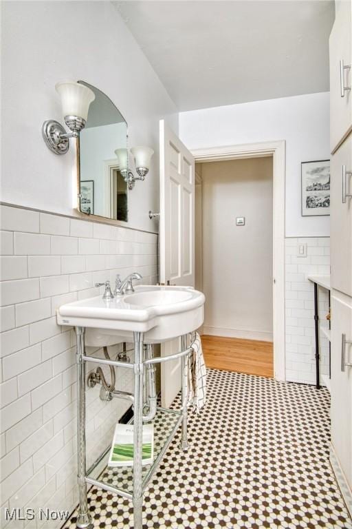 bathroom featuring tile walls and wainscoting