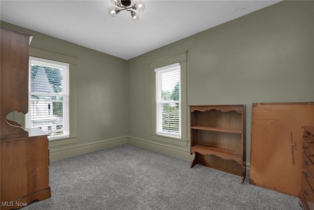 unfurnished bedroom with baseboards and carpet flooring