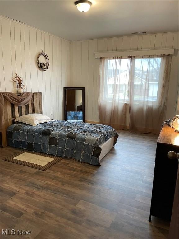 bedroom with wood finished floors and visible vents