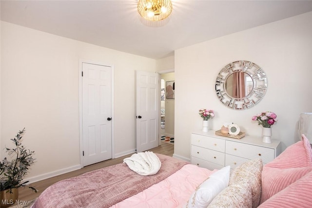 bedroom with wood finished floors and baseboards