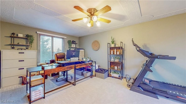 office area with carpet floors, a textured ceiling, and a ceiling fan