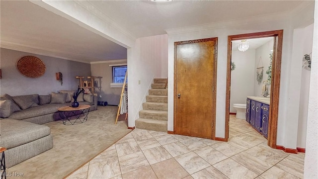 living room with marble finish floor, stairs, and crown molding