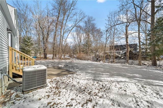 yard covered in snow featuring cooling unit