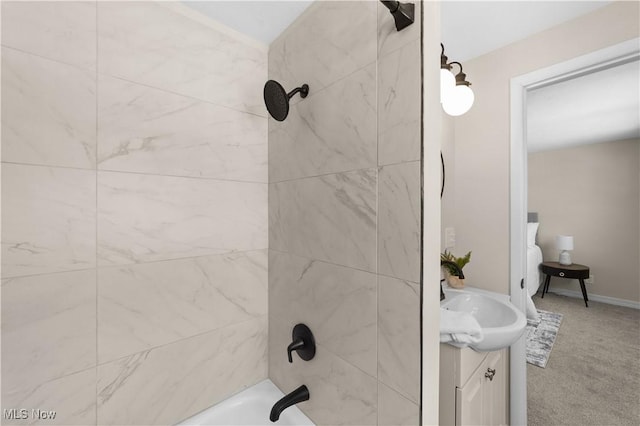 bathroom with washtub / shower combination and vanity