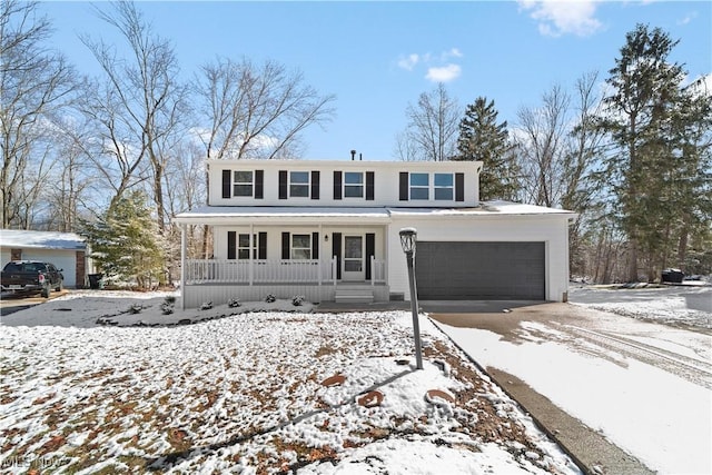 view of front of property featuring a porch, driveway, and a garage