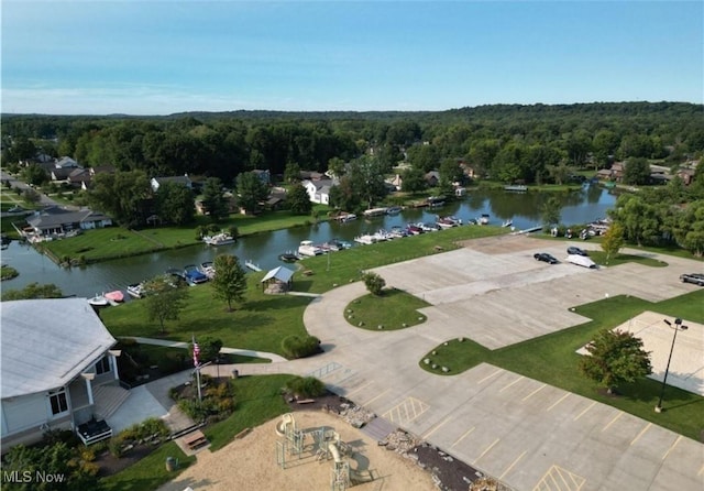 drone / aerial view featuring a forest view and a water view