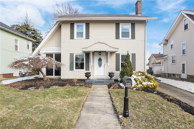 view of front of property with a chimney and a front lawn