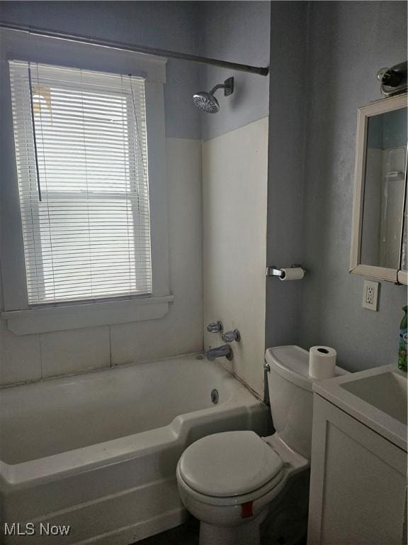 full bathroom featuring toilet, a healthy amount of sunlight, shower / washtub combination, and vanity