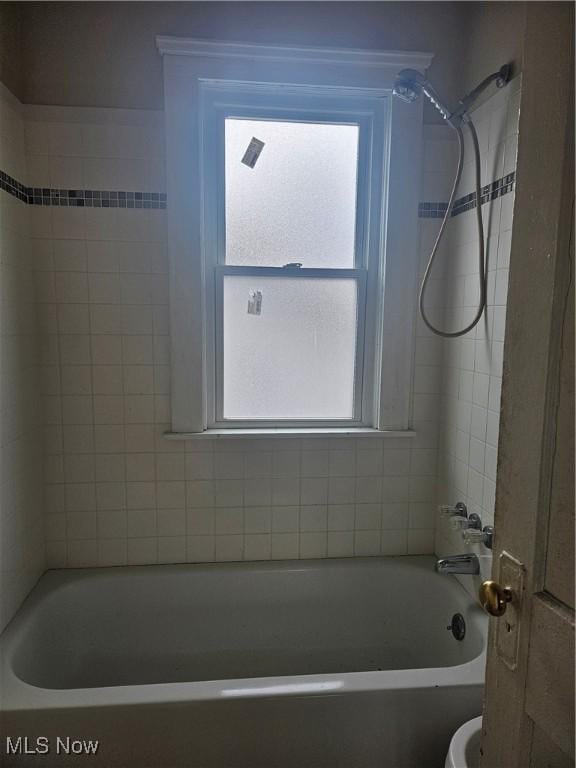 bathroom featuring a healthy amount of sunlight, toilet, and shower / bathing tub combination