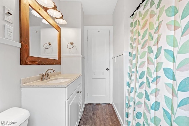 full bathroom featuring toilet, a shower with curtain, wood finished floors, and vanity