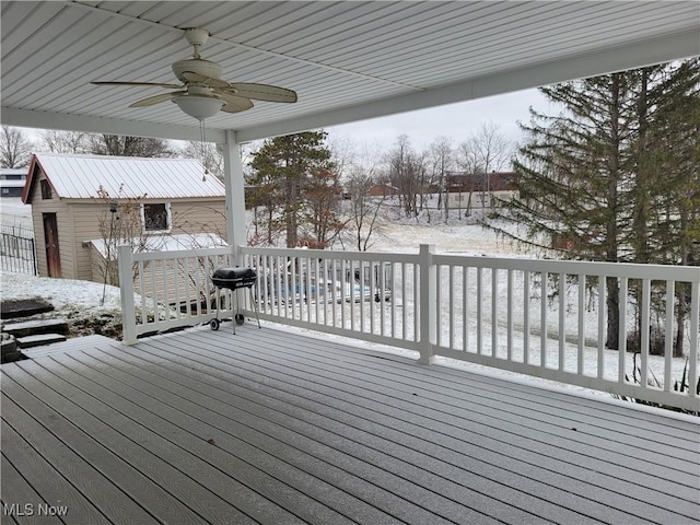 snow covered deck featuring ceiling fan and grilling area