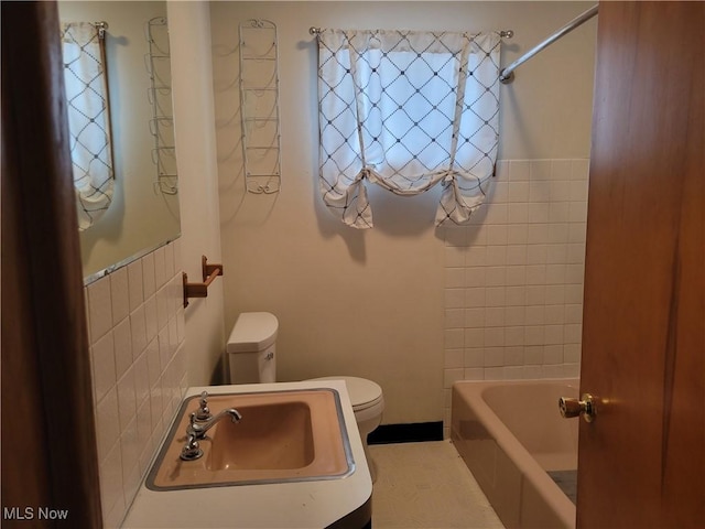 full bathroom with tub / shower combination, a sink, and toilet