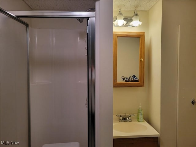 bathroom featuring toilet, an enclosed shower, and vanity