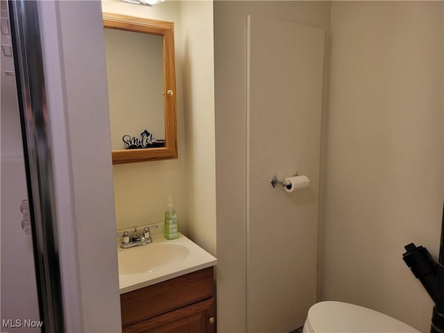 half bath featuring toilet and vanity