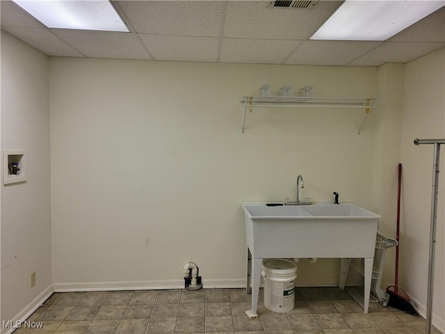 laundry area featuring a sink, laundry area, hookup for a washing machine, and baseboards