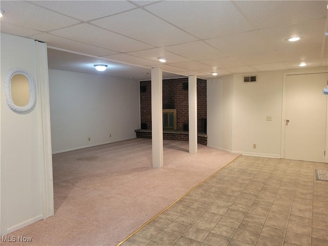 finished basement featuring a paneled ceiling, recessed lighting, visible vents, light carpet, and baseboards