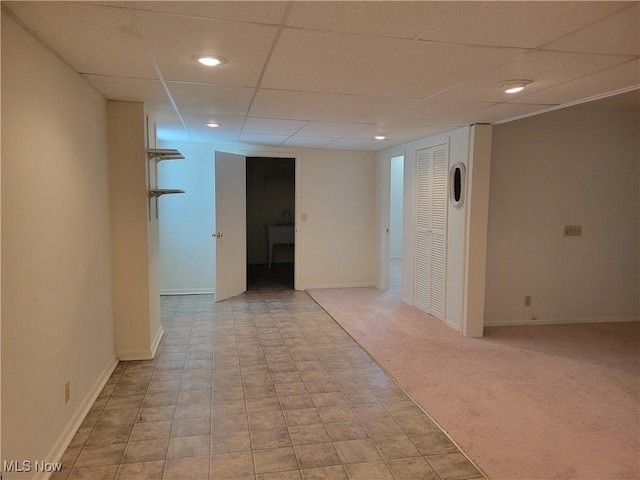 interior space featuring recessed lighting, baseboards, a drop ceiling, and light colored carpet