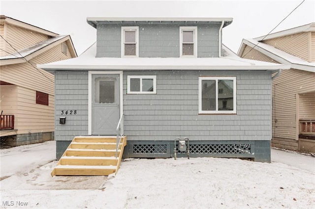 snow covered house with entry steps