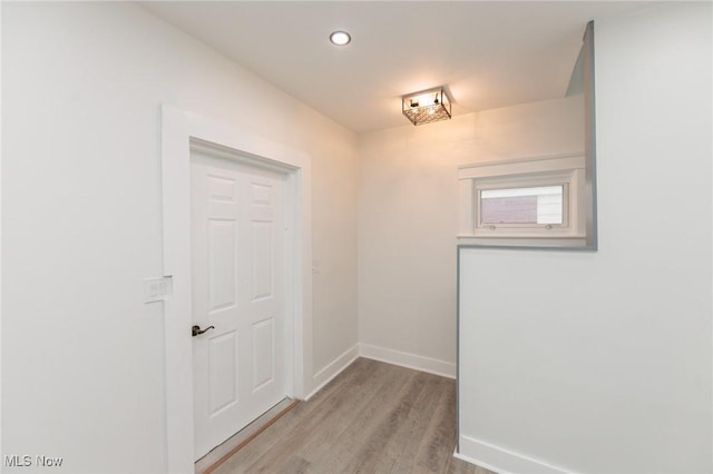 interior space featuring light wood-type flooring, baseboards, and recessed lighting