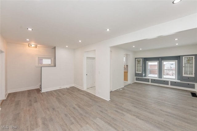 below grade area with baseboards, wood finished floors, and recessed lighting