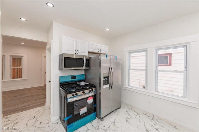 kitchen with stainless steel appliances, recessed lighting, marble finish floor, and baseboards