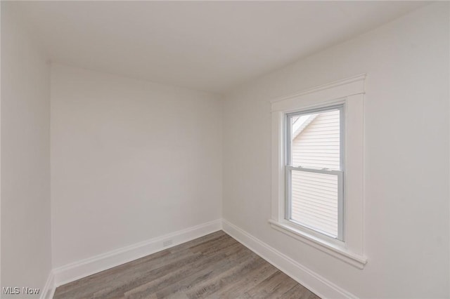 unfurnished room featuring wood finished floors and baseboards