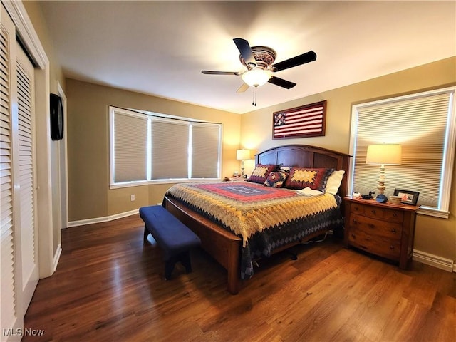 bedroom with a ceiling fan, baseboards, and wood finished floors