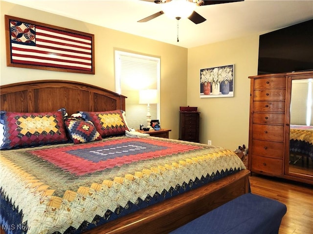 bedroom with ceiling fan and wood finished floors