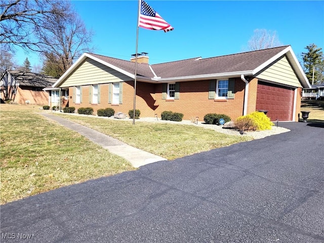 view of front facade featuring a front yard and brick siding