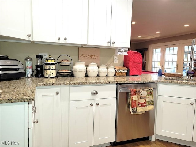 kitchen featuring recessed lighting, white cabinetry, stainless steel dishwasher, and light stone countertops