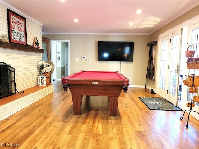 recreation room with light wood finished floors, billiards, and ornamental molding