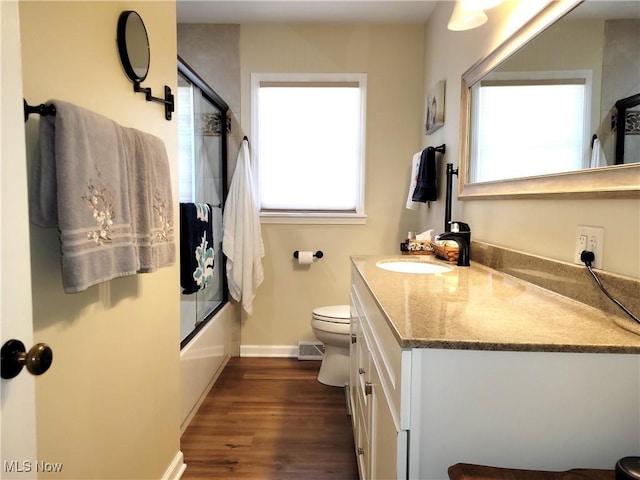 full bath with visible vents, plenty of natural light, vanity, and toilet