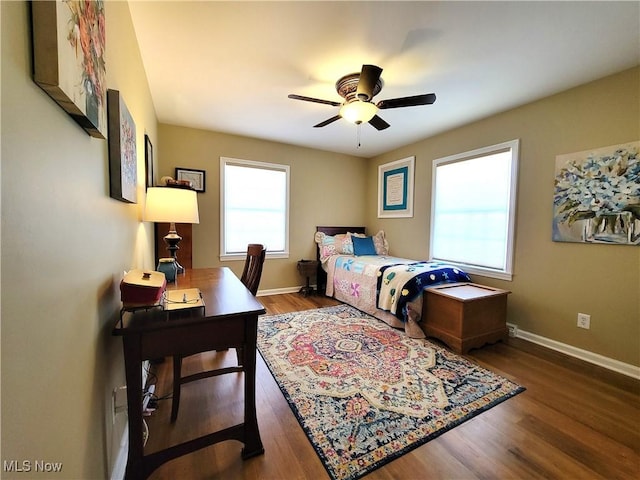 bedroom with a ceiling fan, baseboards, and wood finished floors