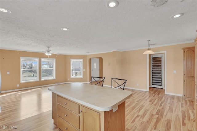 kitchen with arched walkways, light countertops, light wood finished floors, and a kitchen island