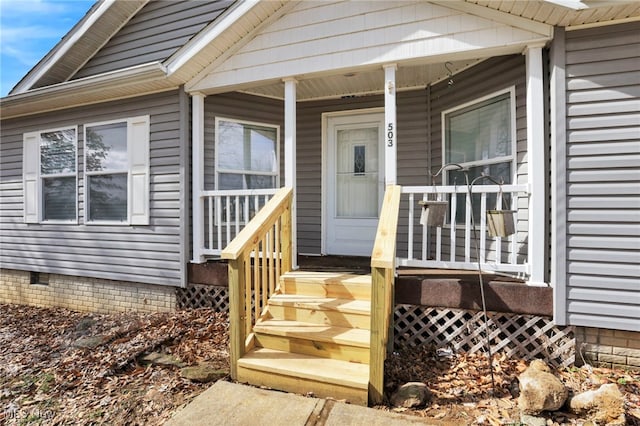 doorway to property with a porch and crawl space