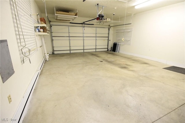 garage with a garage door opener, baseboards, and baseboard heating