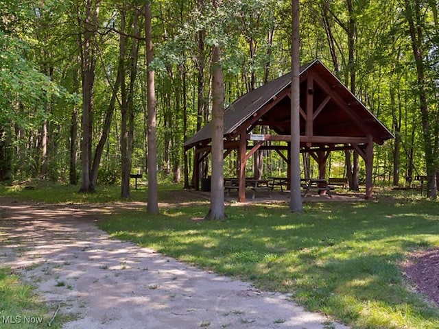 view of home's community featuring a gazebo, a yard, and a forest view