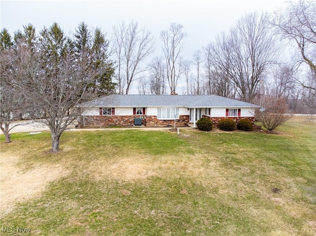 ranch-style house with central AC and a front lawn