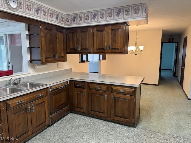 kitchen with dark brown cabinetry, a peninsula, light countertops, and a sink