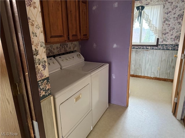 laundry room with cabinet space, independent washer and dryer, wallpapered walls, and baseboards