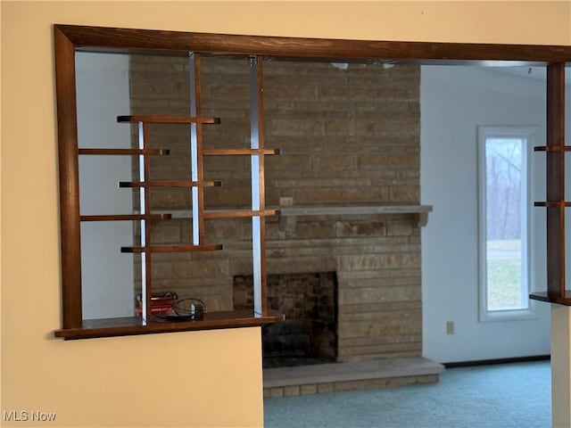 room details with carpet floors and a fireplace with raised hearth