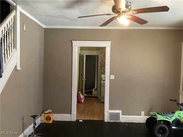 unfurnished room with visible vents, ceiling fan, baseboards, and ornamental molding